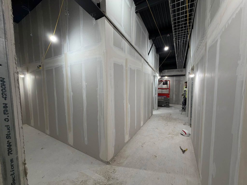 Long run of boarded partition wall